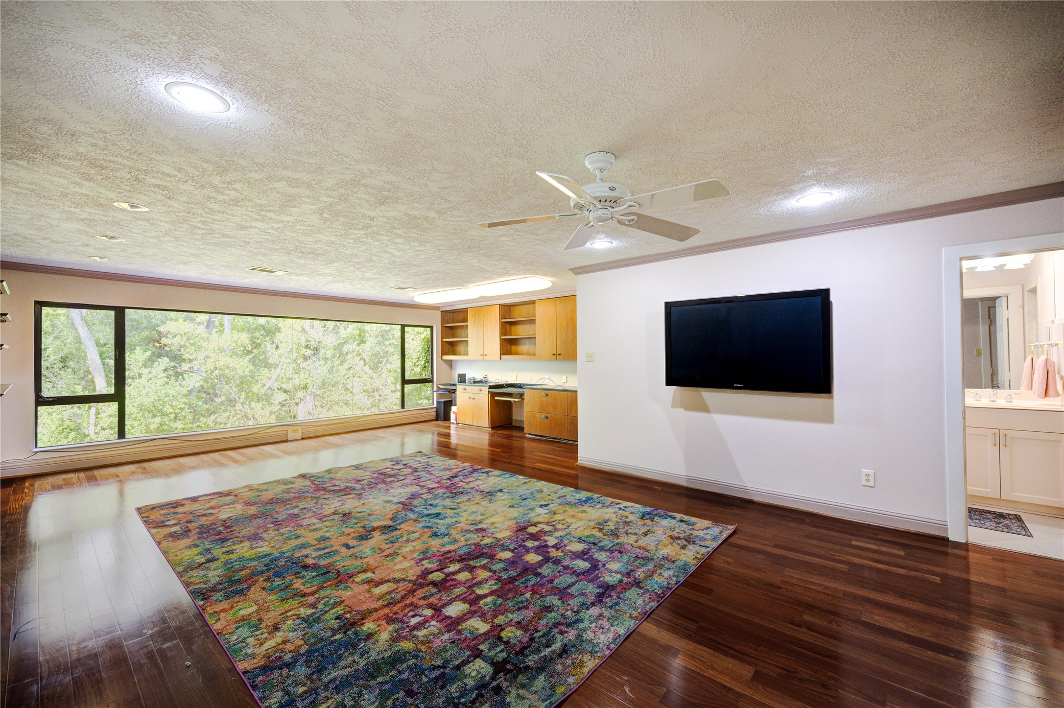 6 Gessner Road Houston, TX 77024 - Photo 33 of 49 a living room with a large bed and a flat screen tv