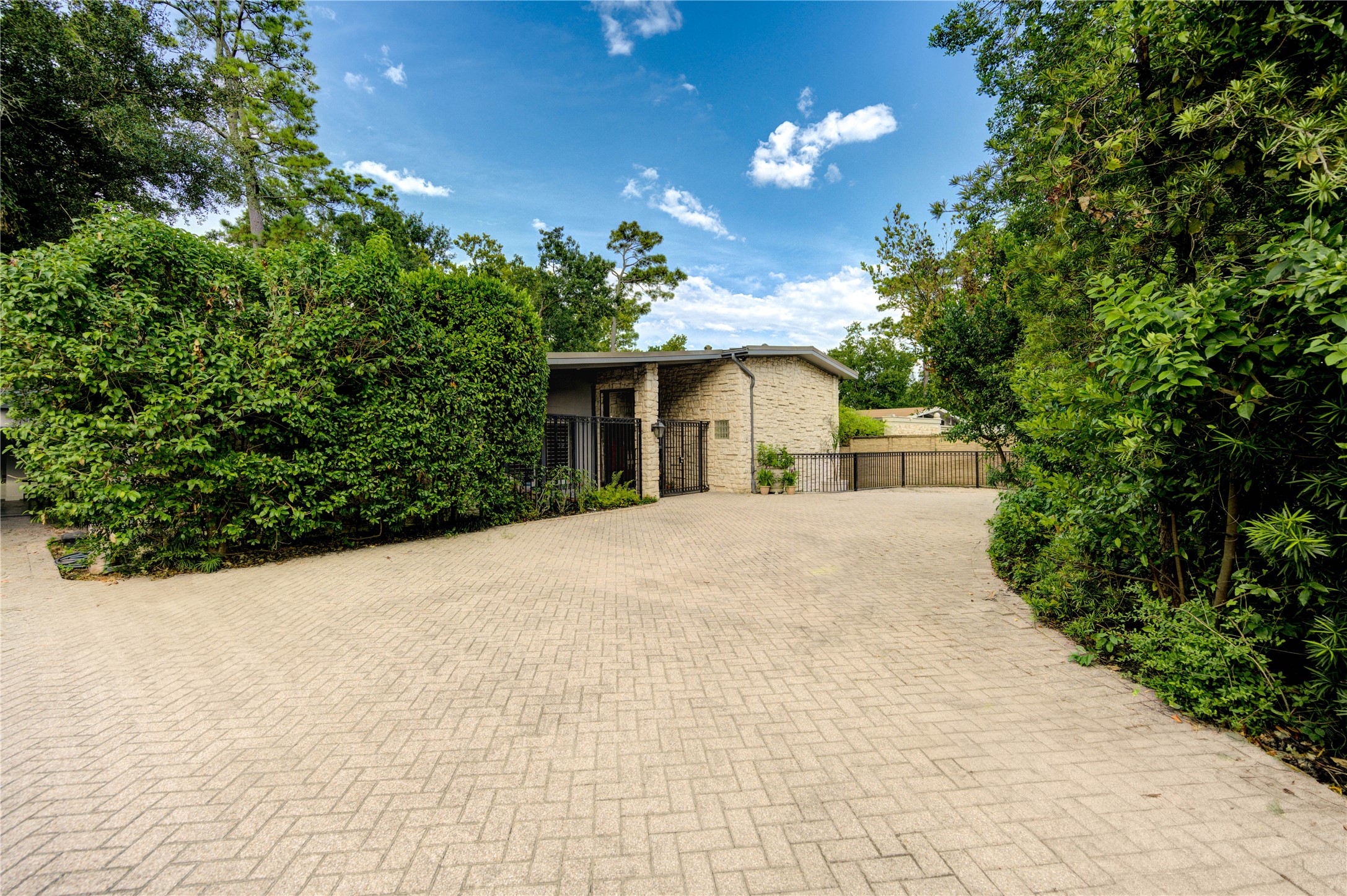 6 Gessner Road Houston, TX 77024 - Photo 4 of 49 a view of a house with a yard and potted plants
