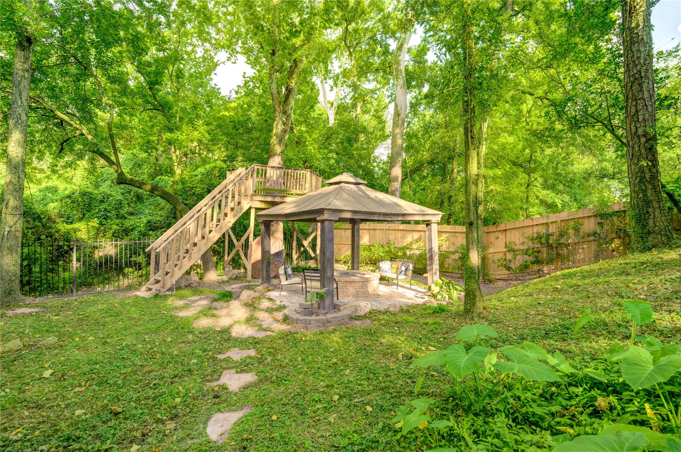 6 Gessner Road Houston, TX 77024 - Photo 43 of 49 a view of a garden with a table and chairs under an umbrella