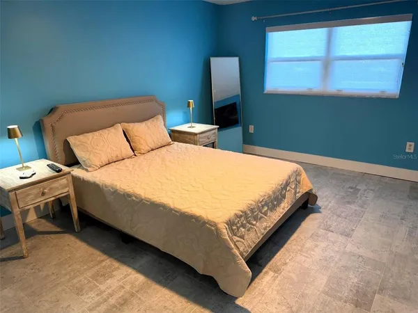 a bedroom with a bed and window