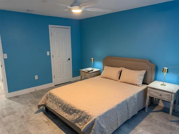 a bedroom with a bed and a lamp