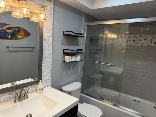 a bathroom with a sink toilet and shower