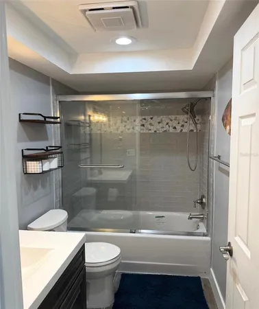 a bathroom with a bathtub shower sink vanity and toilet