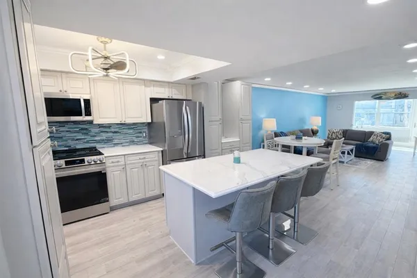 a large kitchen with a table and chairs