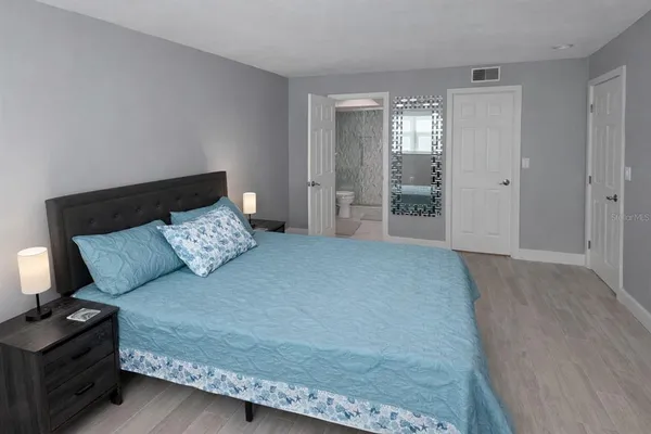 a bed room with a bed and a night stand