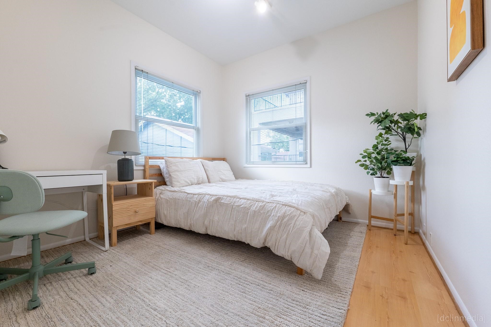 2002 Norfolk Street, Unit A Houston, TX 77098 - Photo 33 of 35 a spacious bedroom with a large bed and a couch