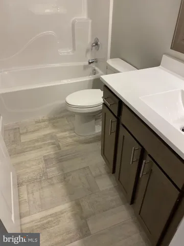 a bathroom with a sink a toilet and a bathtub