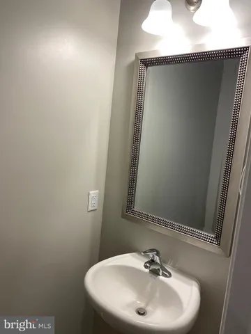 a kitchen with kitchen island granite countertop a sink and a stove top oven