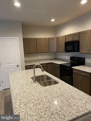 a view of kitchen with stainless steel appliances kitchen island