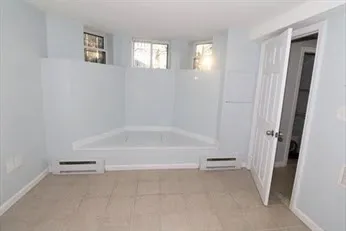 a spacious bathroom with a bathtub and a shower
