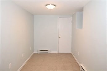 2 Woodbine Street, Unit 1 Boston, MA 02119 - Photo 18 of 20 an empty room with a workbench