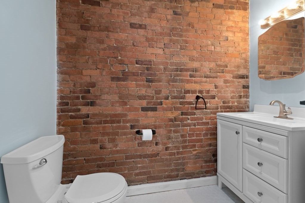 2 Woodbine Street, Unit 1 Boston, MA 02119 - Photo 9 of 20 a bathroom with a toilet and a sink