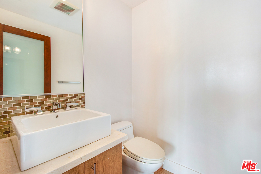 717 South Broadway, Unit B Redondo Beach, CA 90277 - Photo 16 of 29 a bathroom with a sink a toilet and mirror