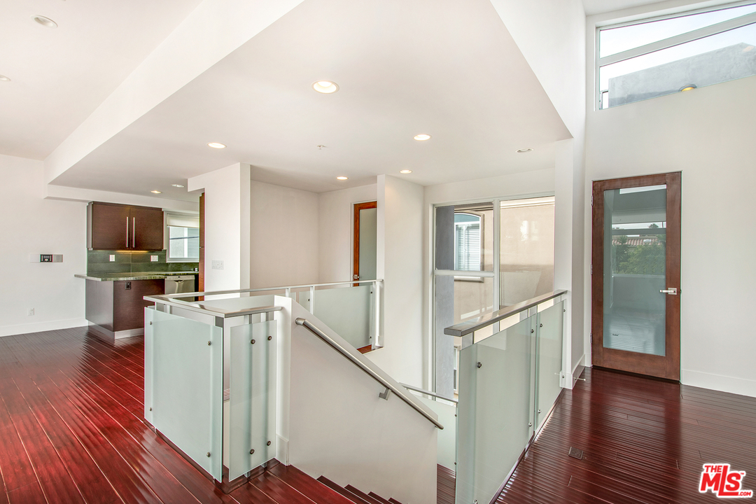 717 South Broadway, Unit B Redondo Beach, CA 90277 - Photo 17 of 29 a view of a kitchen with wooden floor and stairs
