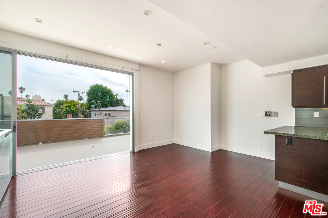 717 South Broadway, Unit B Redondo Beach, CA 90277 - Photo 20 of 29 a view of a living room a kitchen with wooden floor and a large window