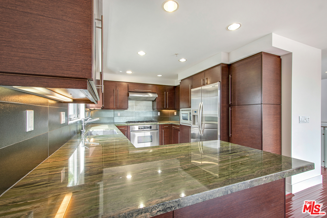 717 South Broadway, Unit B Redondo Beach, CA 90277 - Photo 22 of 29 a kitchen with stainless steel appliances granite countertop a refrigerator a oven and a sink