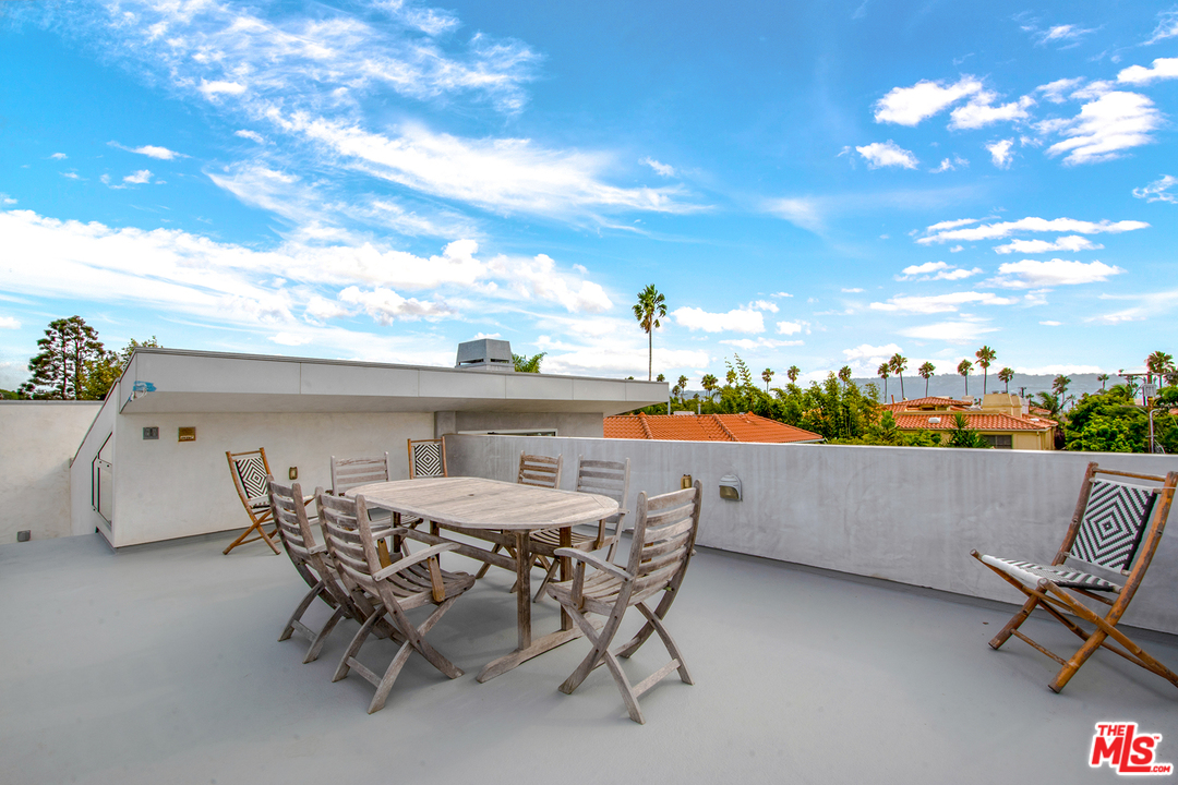 717 South Broadway, Unit B Redondo Beach, CA 90277 - Photo 27 of 29 a view of a patio with table and chairs