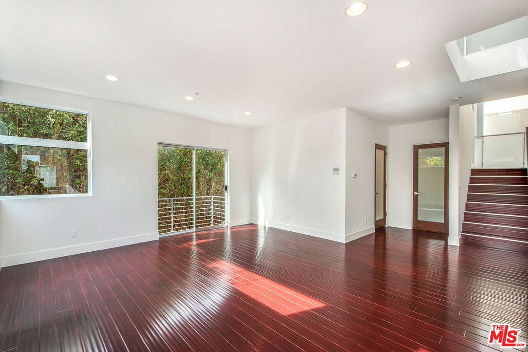 717 South Broadway, Unit B Redondo Beach, CA 90277 - Photo 3 of 29 a view of an empty room with wooden floor and a window