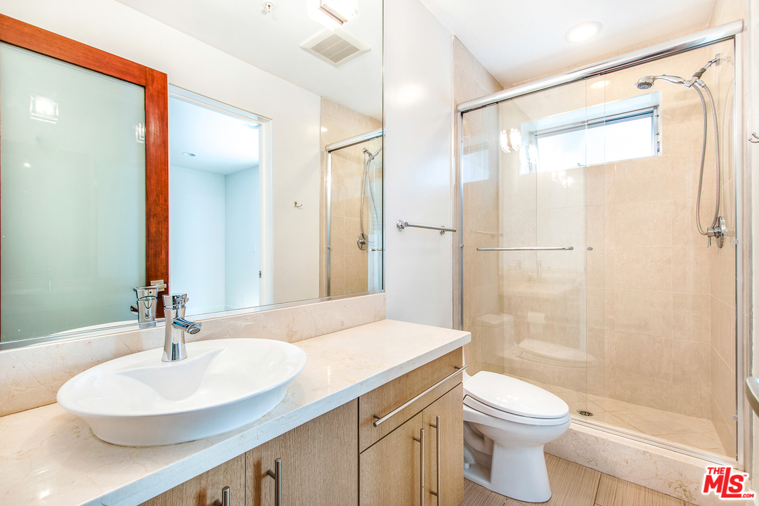 717 South Broadway, Unit B Redondo Beach, CA 90277 - Photo 8 of 29 a bathroom with a sink toilet a mirror and shower