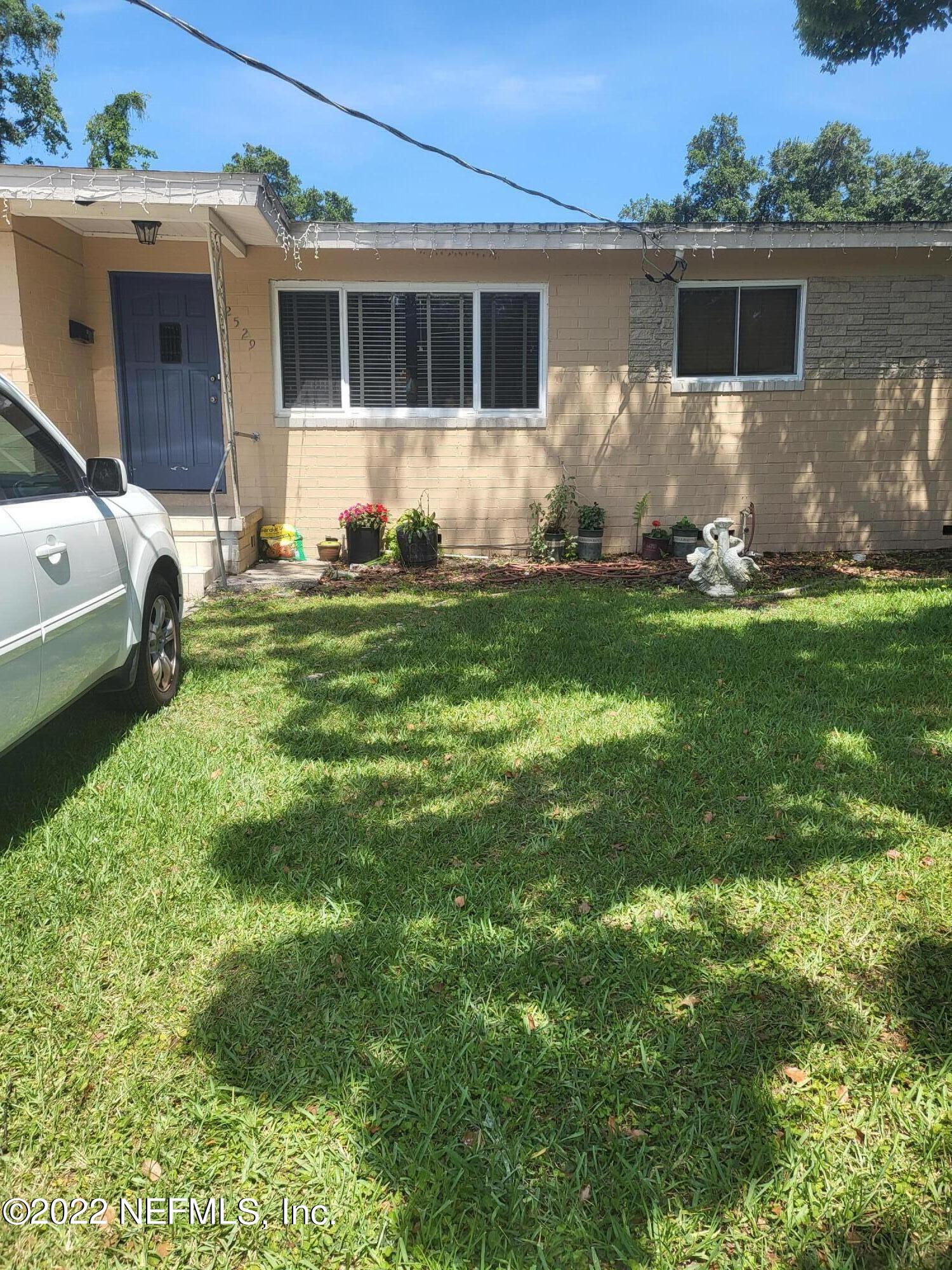 2529 Sam Road Jacksonville, FL 32216 - Photo 1 of 12 a backyard of a house with table and chairs