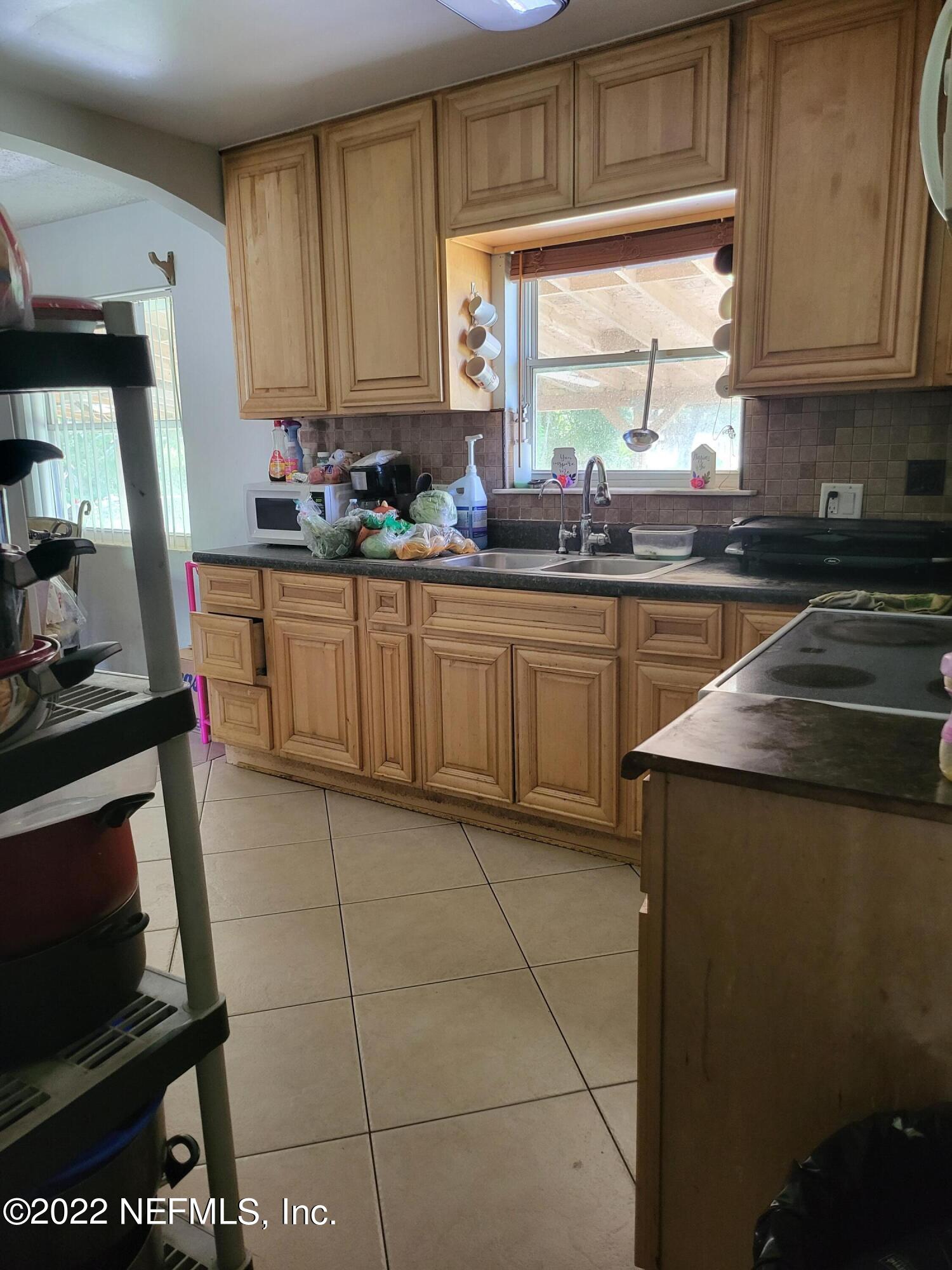 2529 Sam Road Jacksonville, FL 32216 - Photo 3 of 12 a kitchen with stainless steel appliances granite countertop a stove a sink and a microwave