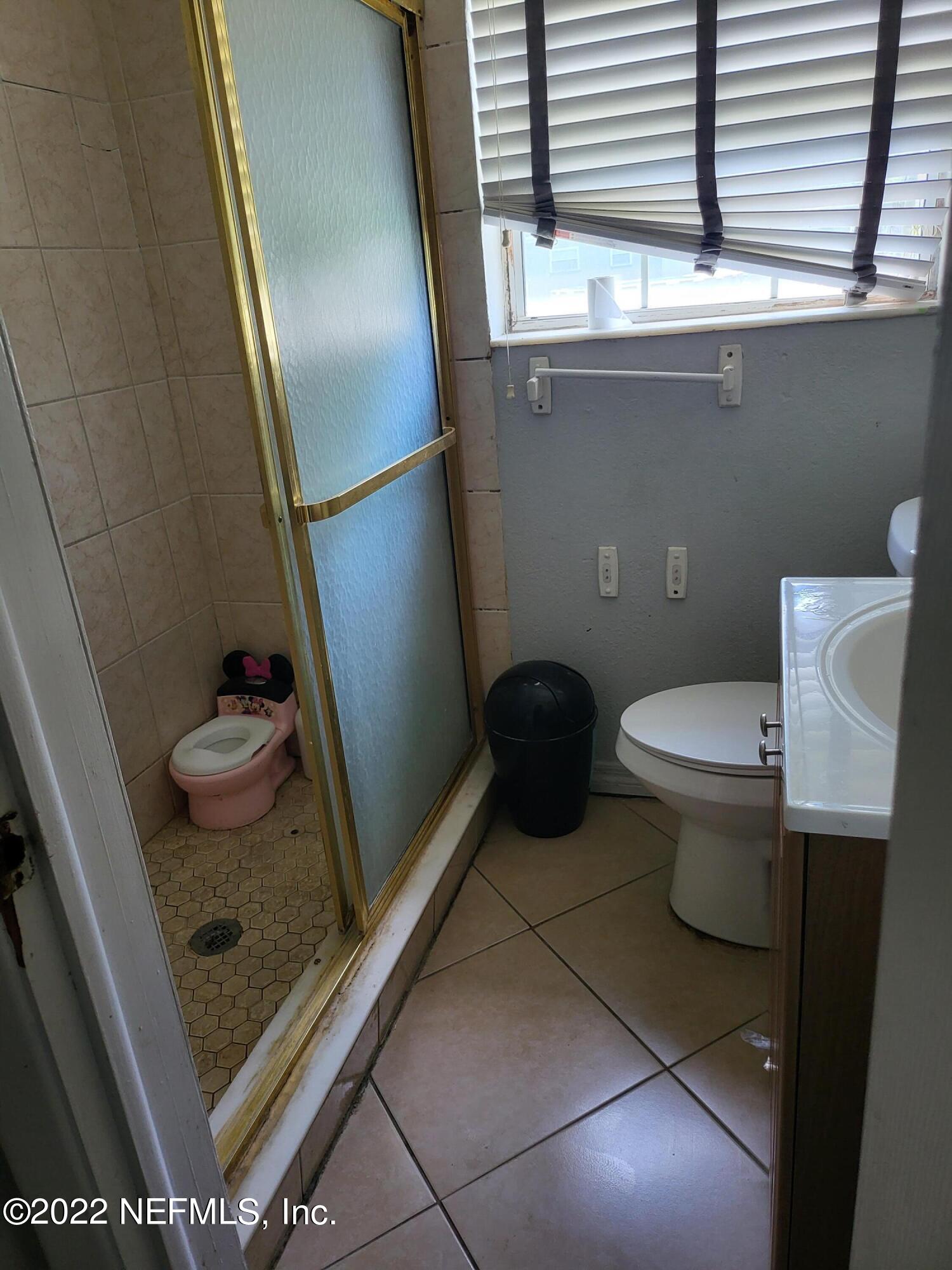 2529 Sam Road Jacksonville, FL 32216 - Photo 7 of 12 a bathroom with a granite countertop sink and a toilet