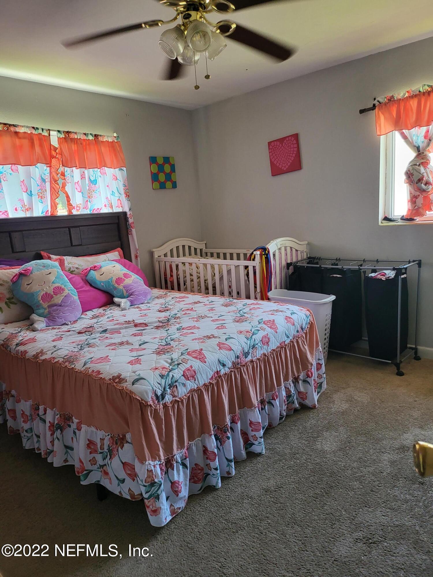 2529 Sam Road Jacksonville, FL 32216 - Photo 10 of 12 a bedroom with a bed and dresser