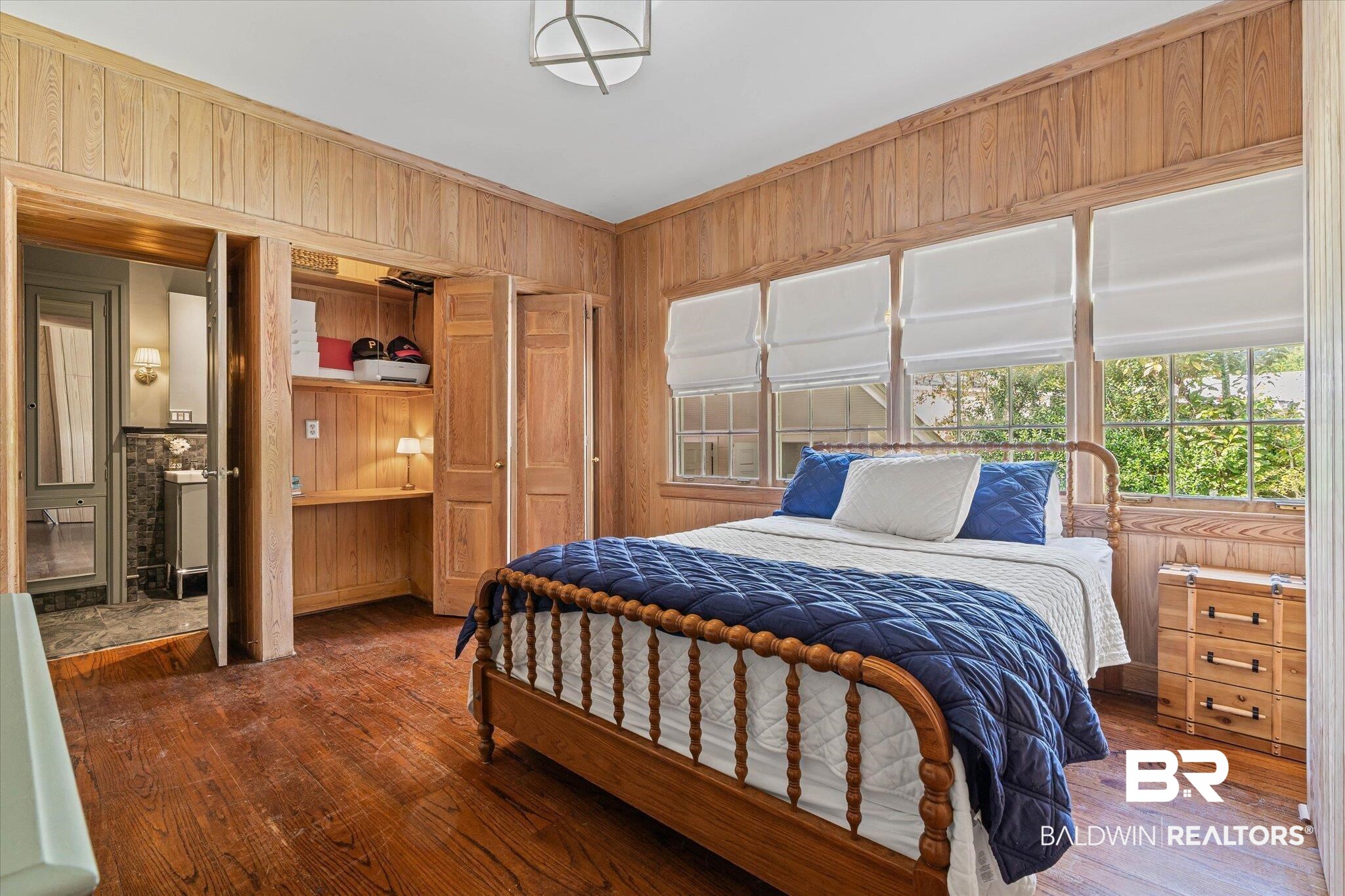 151 Tuthill Lane Mobile, AL 36608 - Photo 19 of 41 Bedroom with wooden walls, hardwood / wood-style floors, crown molding, and a closet