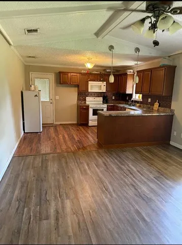 a view of a room with wooden floor