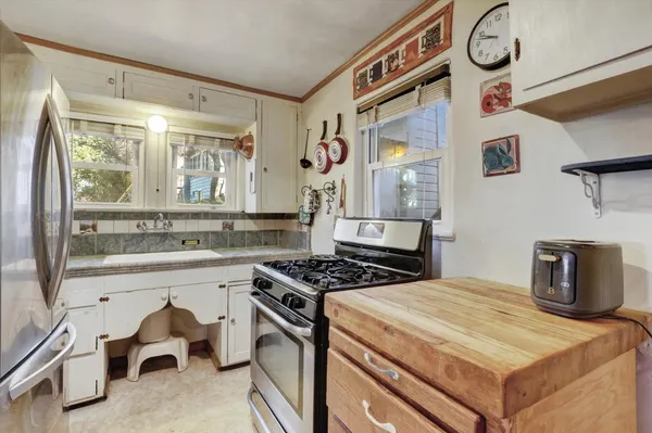 a kitchen with refrigerator and cabinets