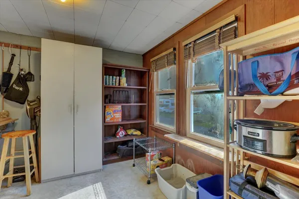 a view of a white house with a yard and plants