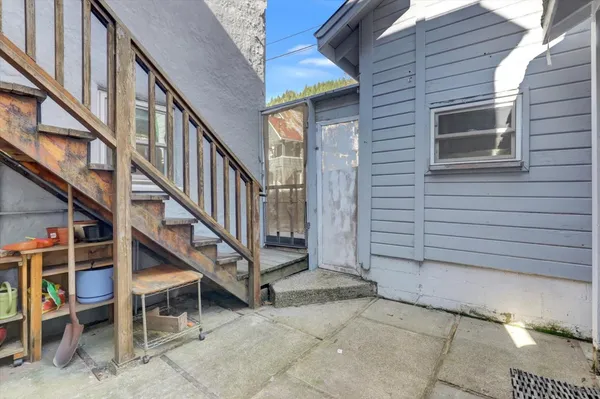 a view of a patio with table and chairs with wooden floor and fence