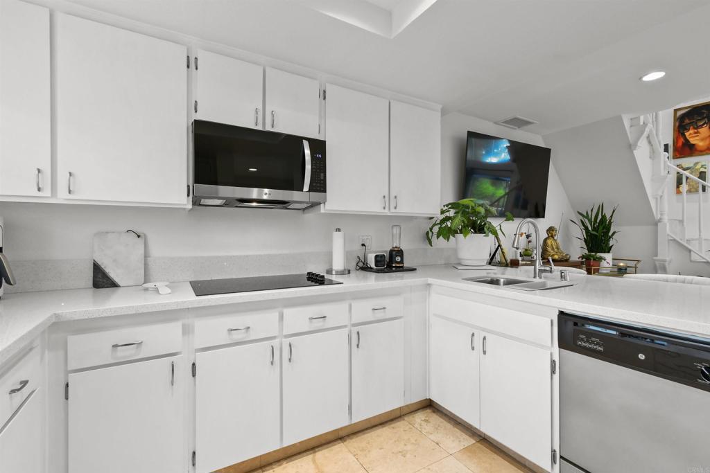 760 Eastshore Terrace, Unit 139 Chula Vista, CA 91913 - Photo 11 of 34 a kitchen with a sink stove and cabinets
