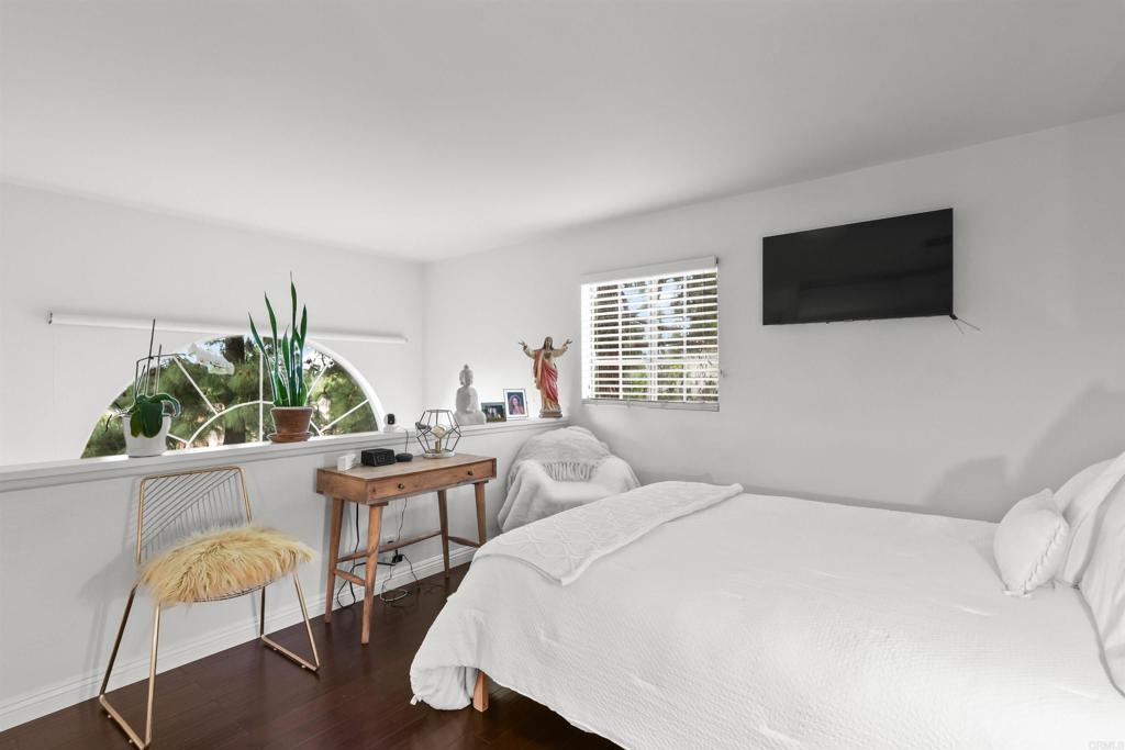 760 Eastshore Terrace, Unit 139 Chula Vista, CA 91913 - Photo 15 of 34 a bedroom with furniture and a flat screen tv