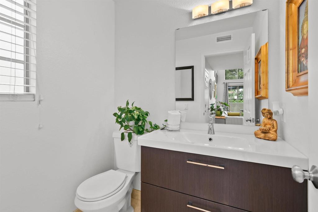 760 Eastshore Terrace, Unit 139 Chula Vista, CA 91913 - Photo 8 of 34 a bathroom with a sink a toilet a mirror and shower