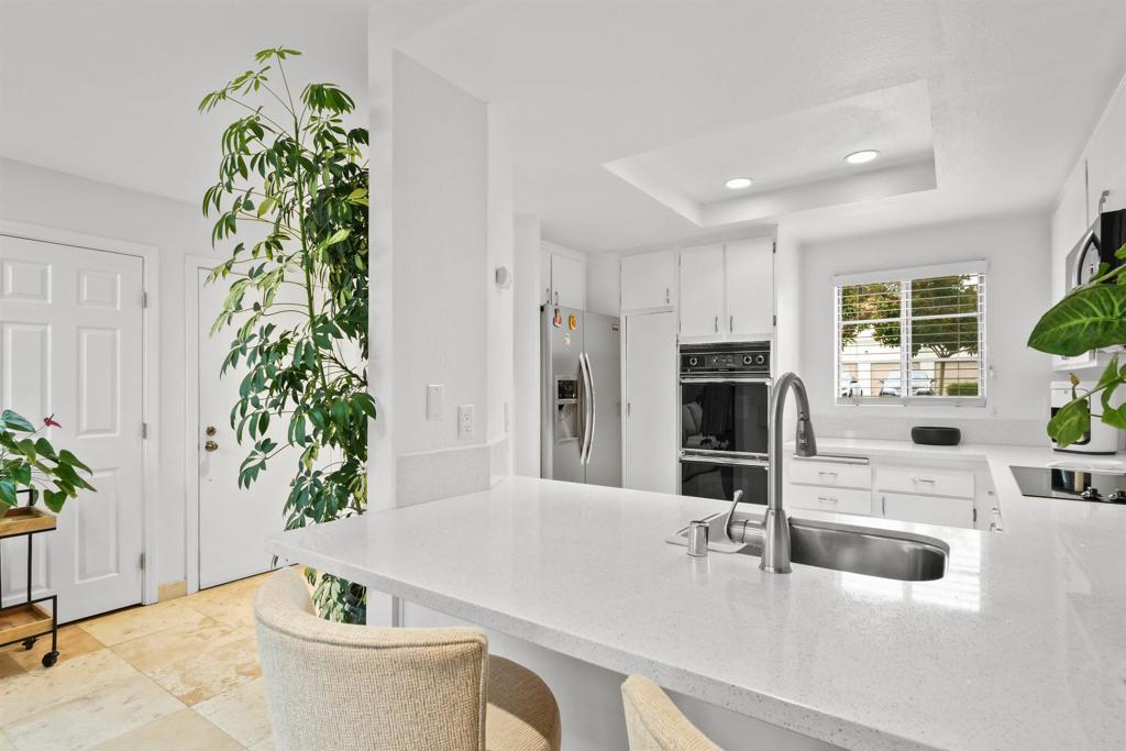 760 Eastshore Terrace, Unit 139 Chula Vista, CA 91913 - Photo 9 of 34 a large white kitchen with a potted plant