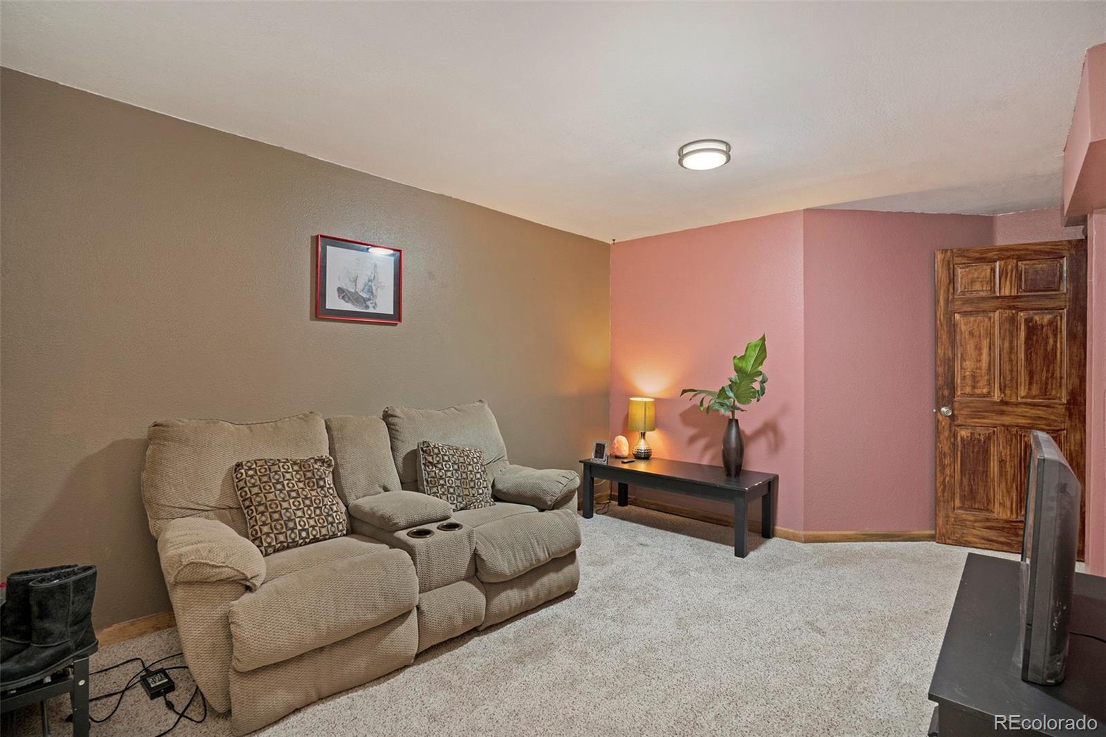 249 Burland Drive Bailey, CO 80421 - Photo 15 of 24 a living room with furniture and a flat screen tv