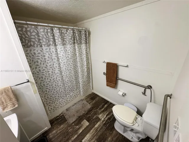 a bathroom with a toilet sink and a shower