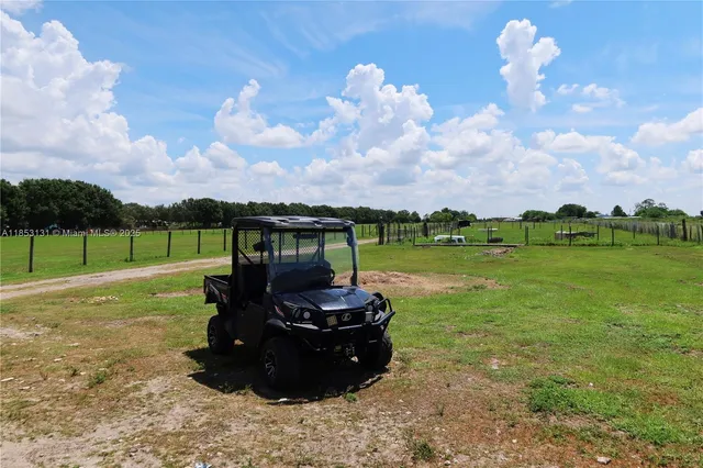 a view of a house with a small yard and wooden fence