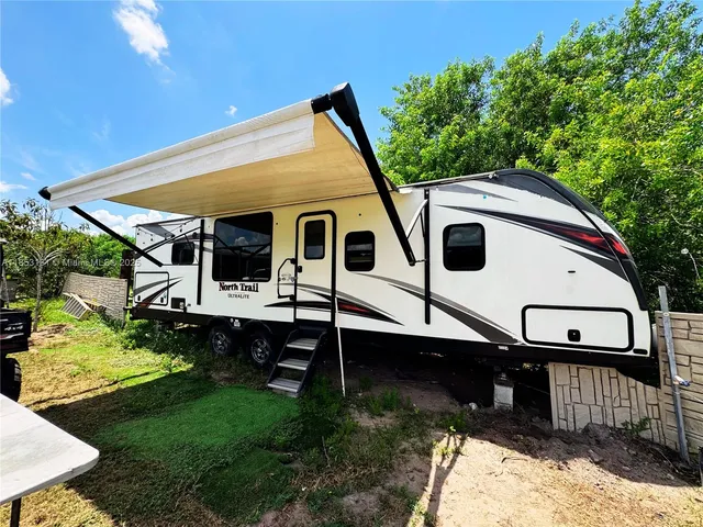 a living room with furniture a rug and a fireplace