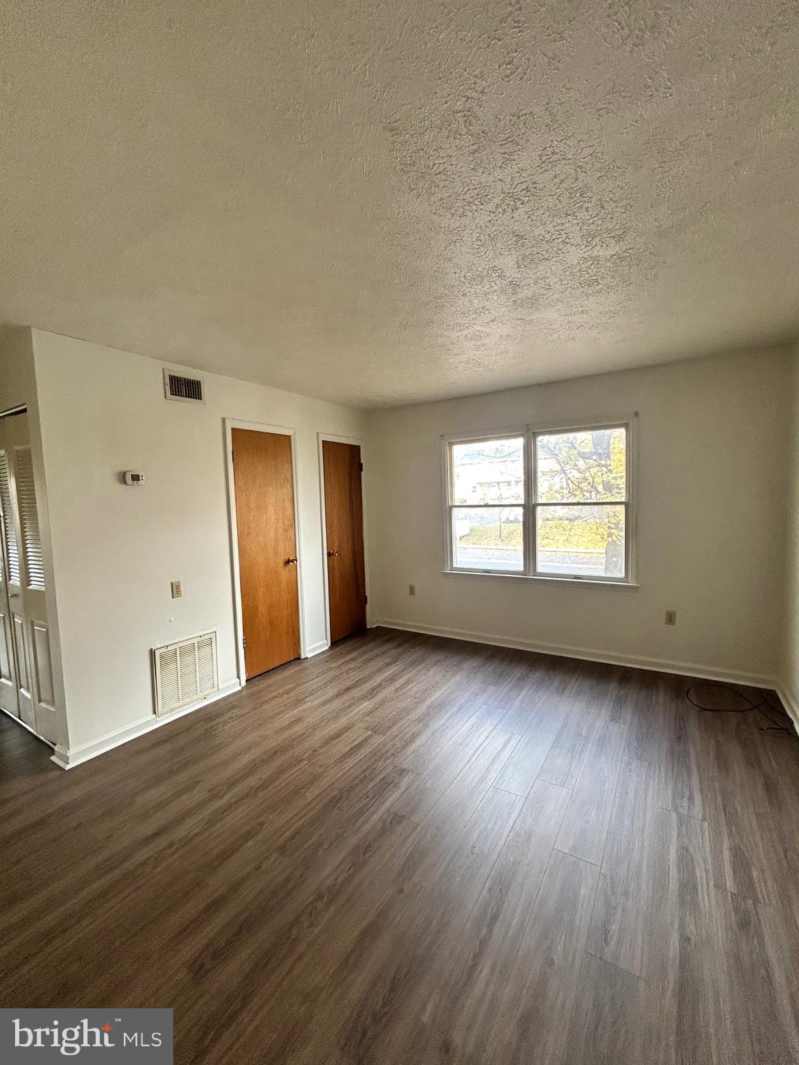 2401 Papermill Road, Unit 5 Winchester, VA 22601 - Photo 2 of 7 a view of an empty room with wooden floor and a window