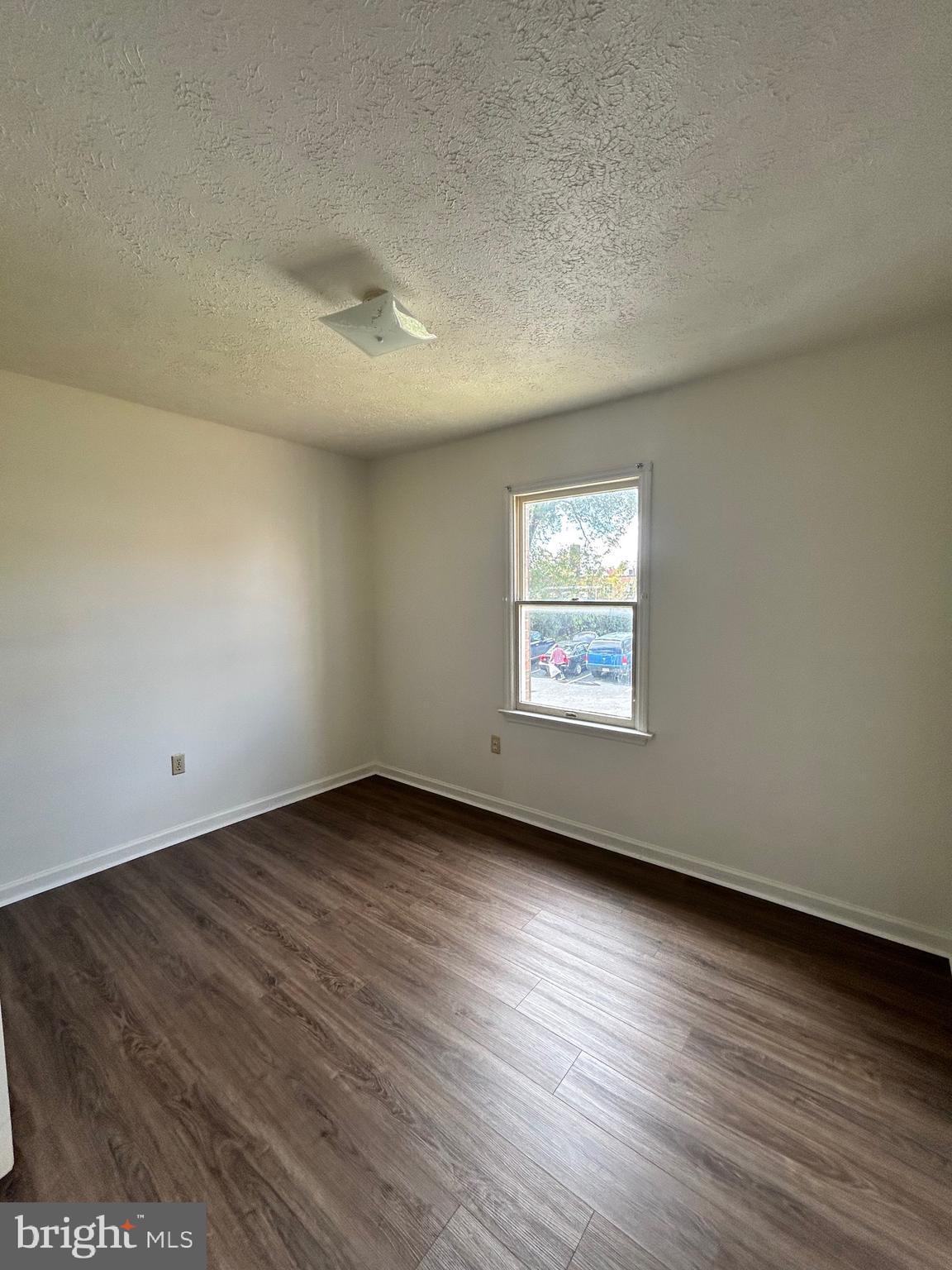 2401 Papermill Road, Unit 5 Winchester, VA 22601 - Photo 6 of 7 an empty room with wooden floor and windows