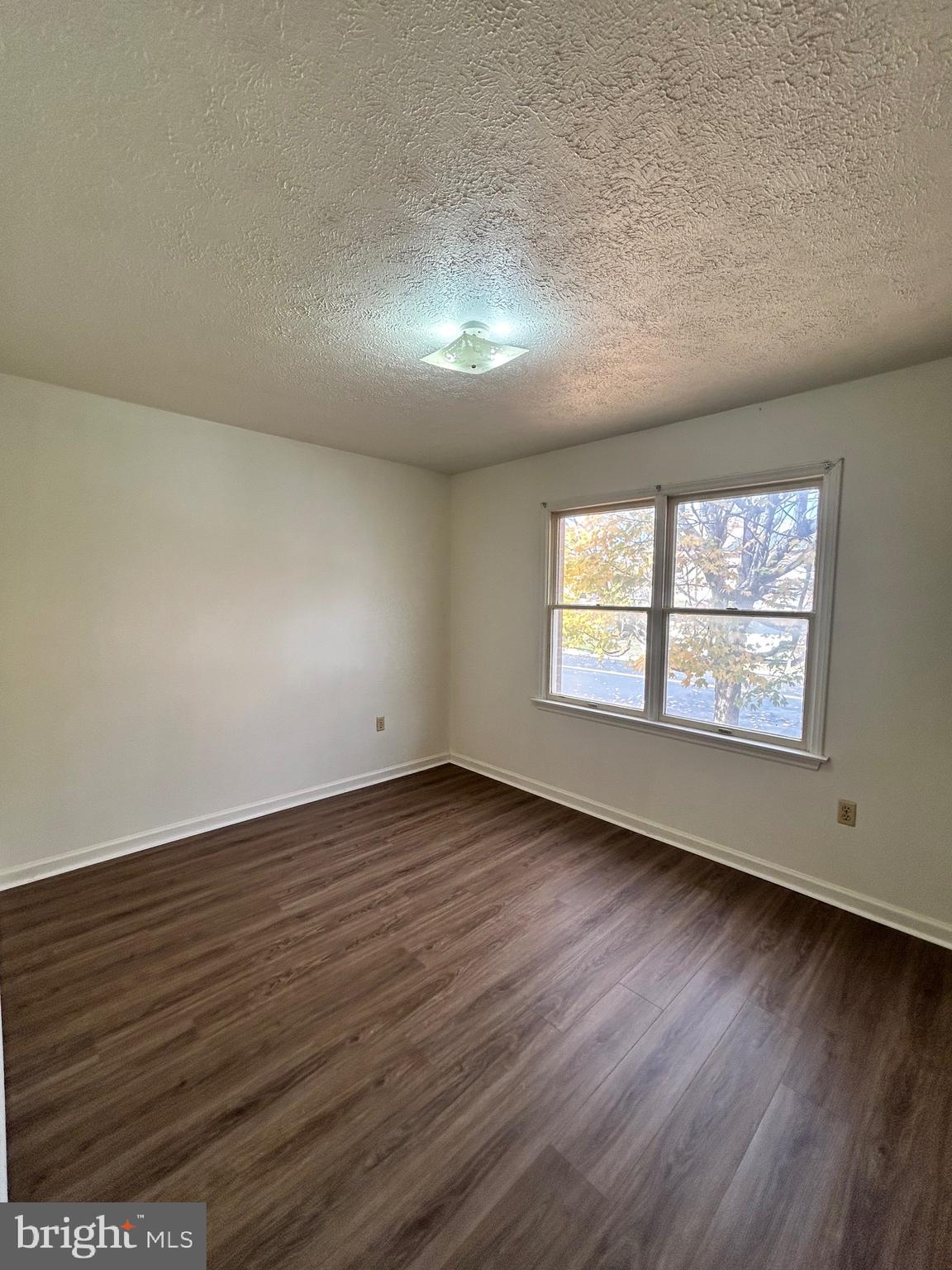 2401 Papermill Road, Unit 5 Winchester, VA 22601 - Photo 7 of 7 an empty room with wooden floor and windows