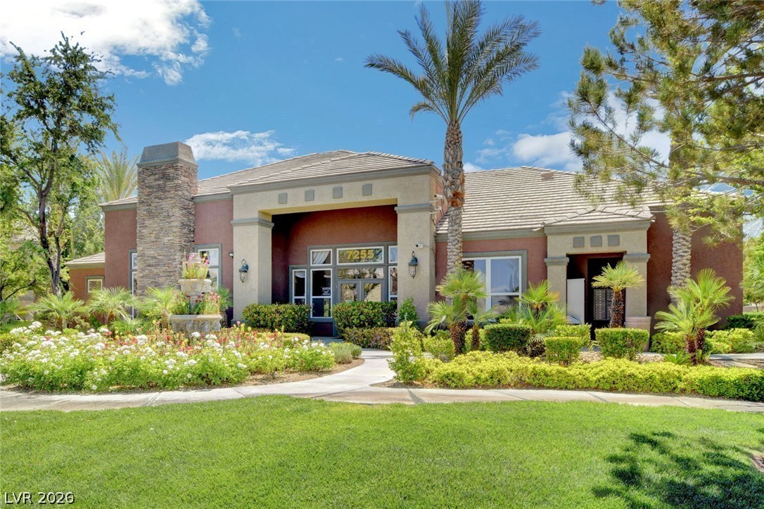 7255 West Sunset Road, Unit 2078 Las Vegas, NV 89113 - Photo 26 of 34 A terracotta-hued clubhouse with stately stone accents and lush, vibrant landscaping invites residents inside.