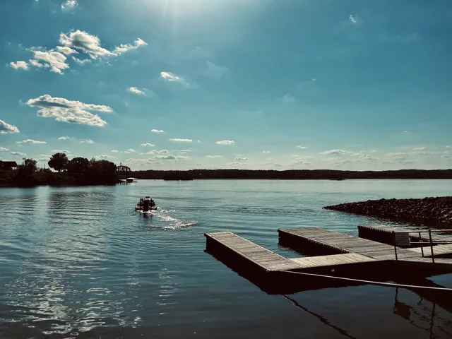 a view of a lake with couches chairs