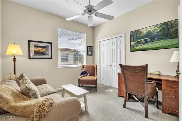 a living room with furniture and a lamp