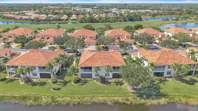 an aerial view of lake and residential houses with outdoor space