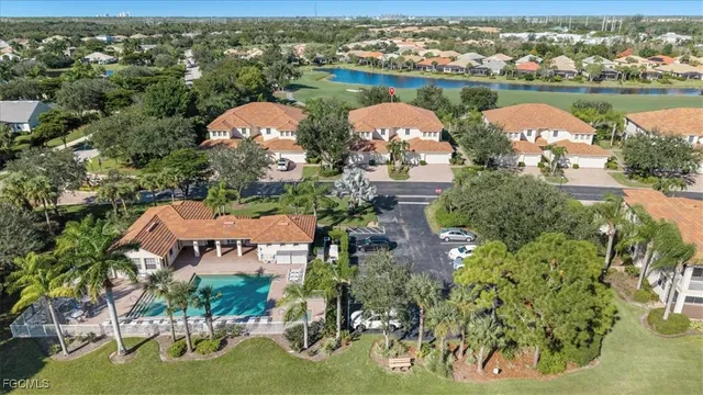 an aerial view of a house with outdoor space and lake view