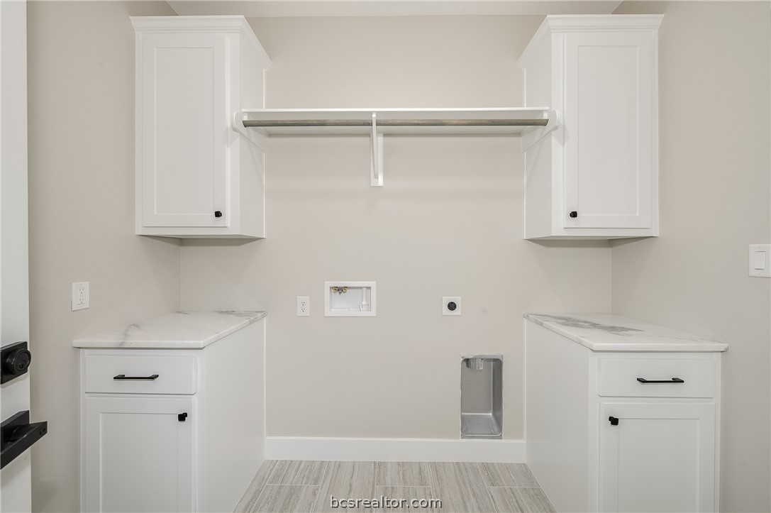 2908 GOLDBERG Drive Bryan, TX 77808 - Photo 13 of 44 Utility room features storage cabinets, drying rod and vinyl flooring.