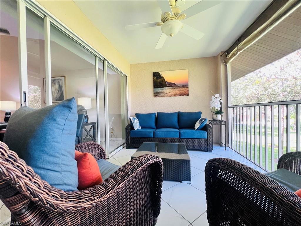 8073 Panther Trail, Unit 1404 Naples, FL 34113 - Photo 22 of 29 a living room with furniture and a window